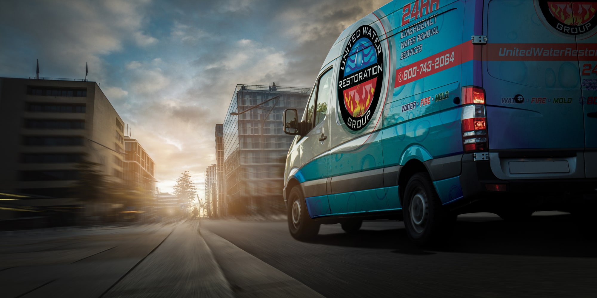 A United Water Restoration Group of The Woodlands van heading out on an emergency call at sunset